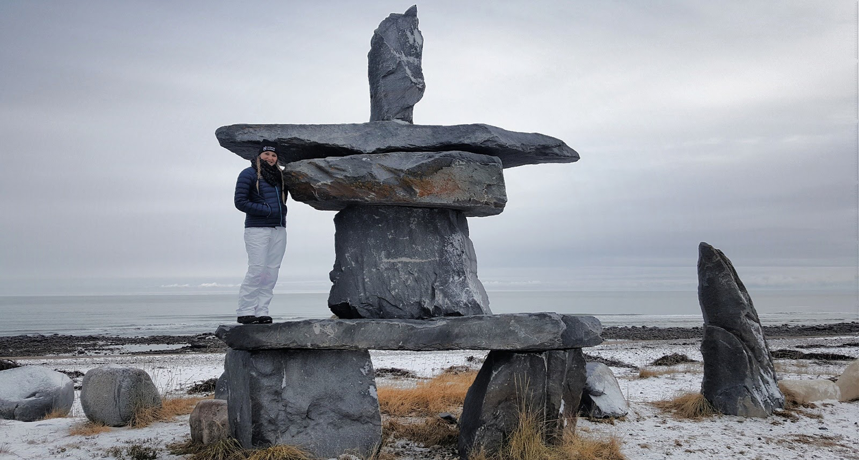 Posing with the famous Inukshuk in Churchill, Canada!